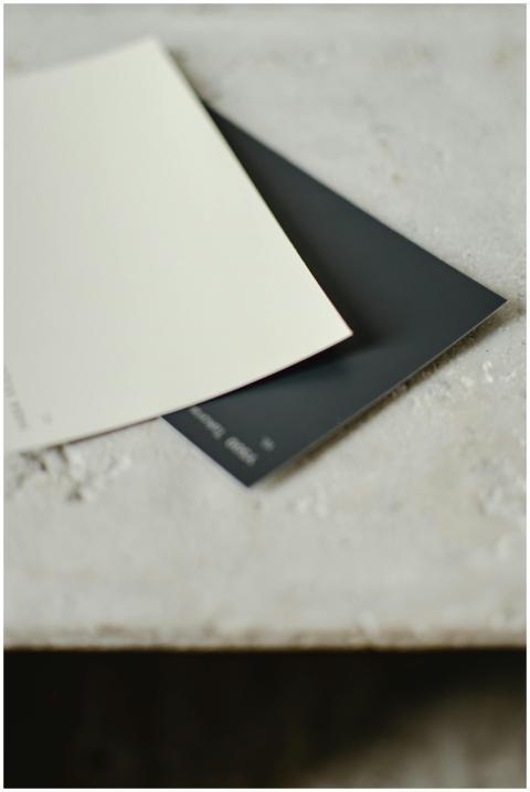 Two color swatches on a textured surface with a mi