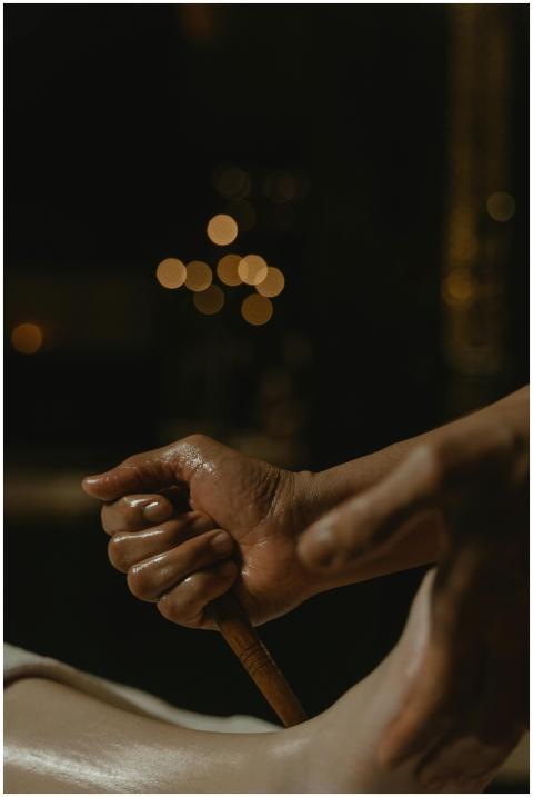 A detailed view of a hand using a wooden stick dur
