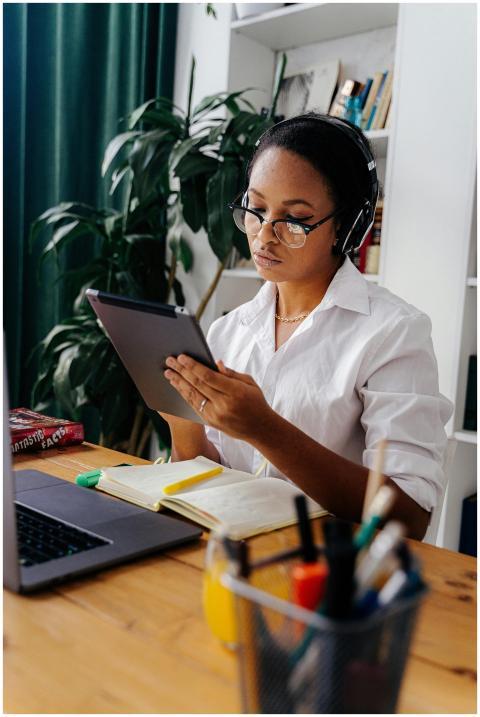 Young black woman with headphones studying using a