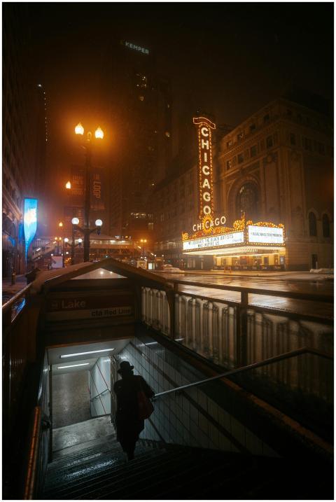 Dramatic night view of Chicago Theater with person