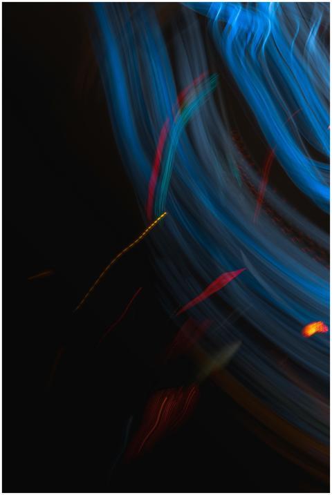 Dynamic abstract art featuring colorful light trai