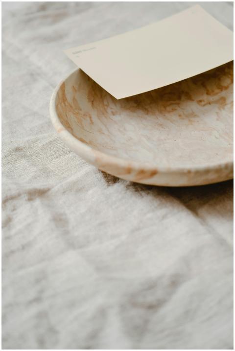 Elegant handmade ceramic plate on textured linen w