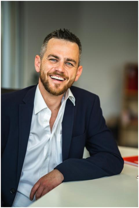 Business professional in suit smiling confidently