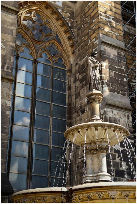 Gothic-style facade and fountain in Cologne, Germa