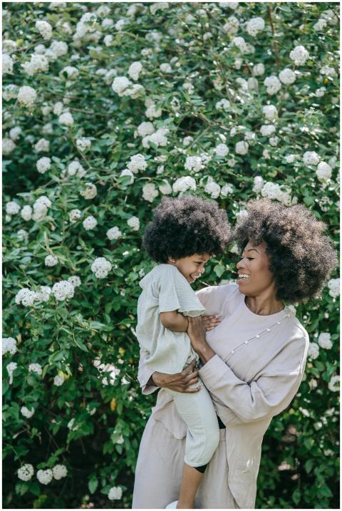 A mother and daughter share a joyful moment surrou