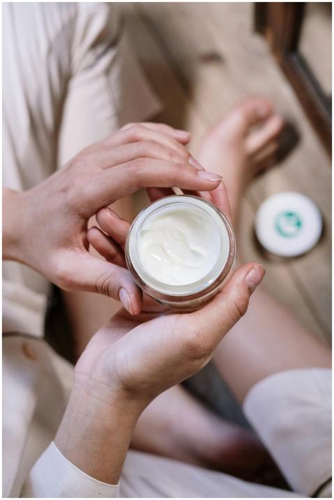 Close-up of woman's hands applying skincare cream