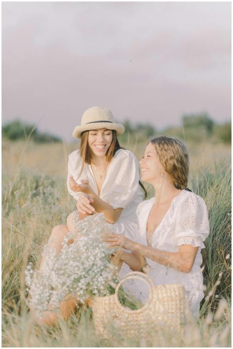 Two women enjoying a sunny day in a serene grass f