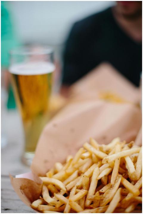 Appetizing french fries and a chilled beer make fo