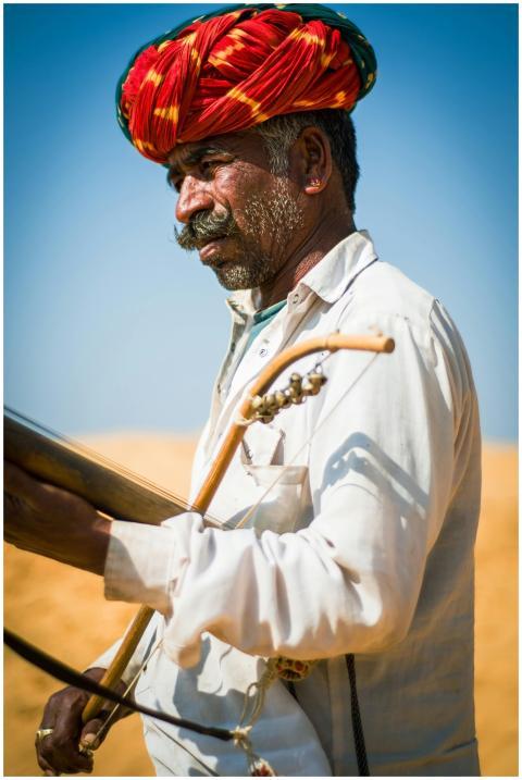 Portrait of a Rajasthani musician playing an instr