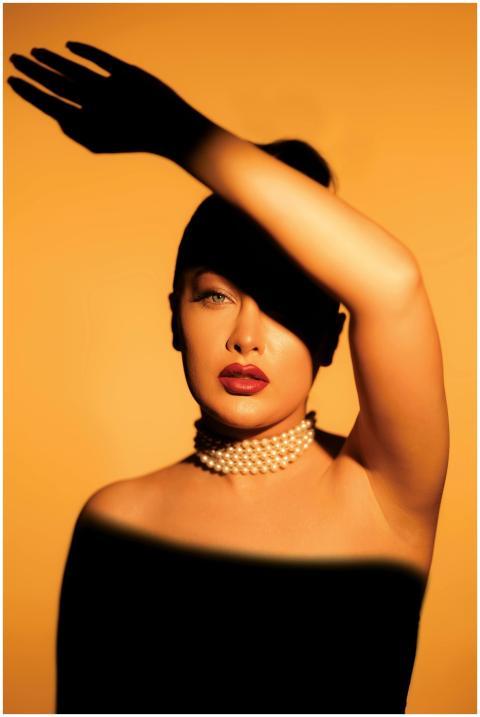 Stylish portrait of woman with pearls in dramatic