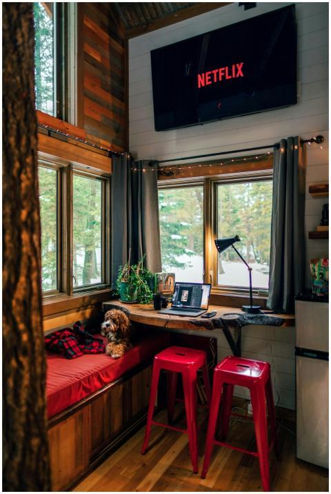 A comfortable cabin interior featuring red stools,