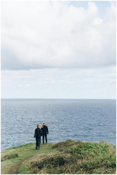 Couple enjoying a peaceful walk along a grassy cli