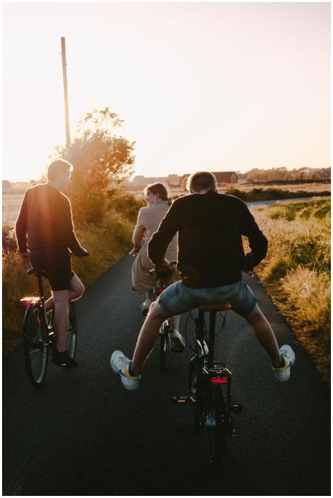 Group of teenagers riding bicycles on a rural road