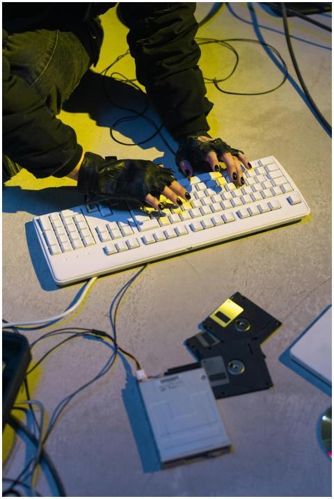 Cyberpunk-themed image showing a hacker typing on