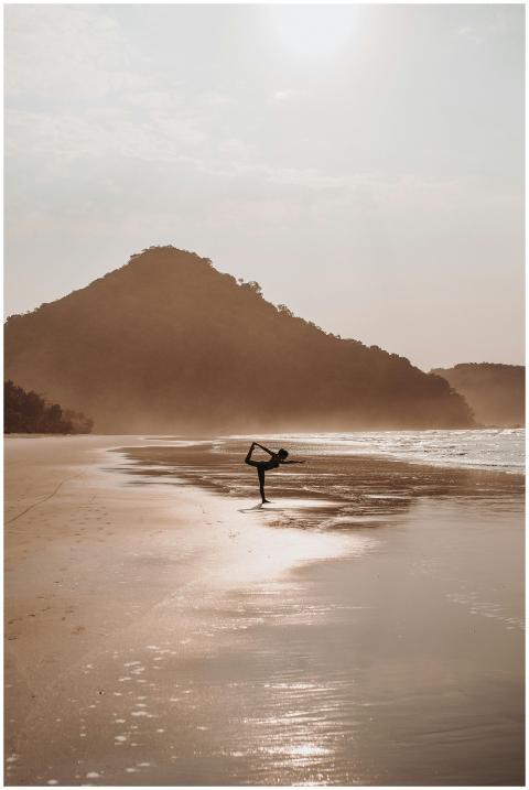 Silhouette of a woman practicing yoga on a tranqui