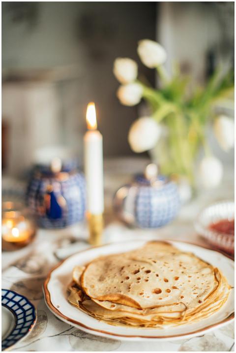 A cozy setup featuring traditional crepes and cand