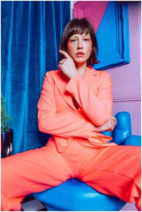 Striking portrait of a woman in a bright neon suit