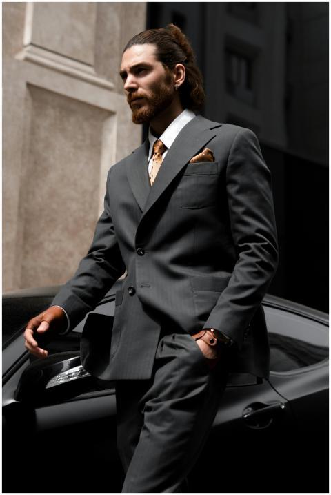 Sophisticated businessman in suit walking past a l