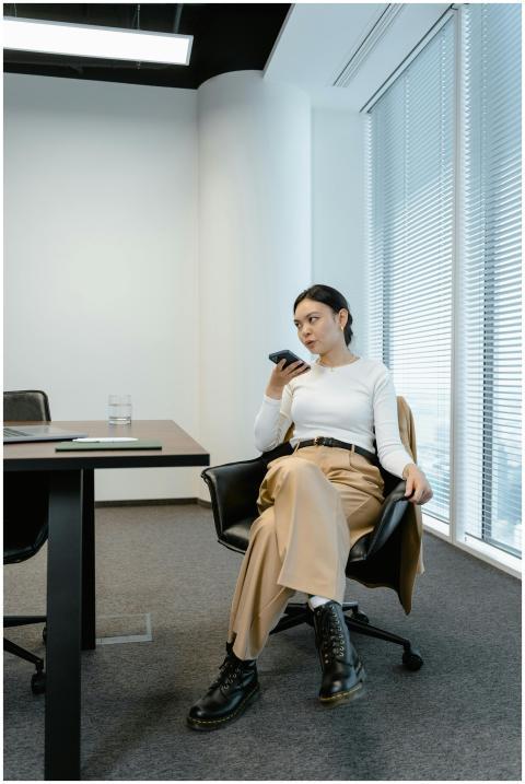 Modern office scene with a woman engaged in a phon