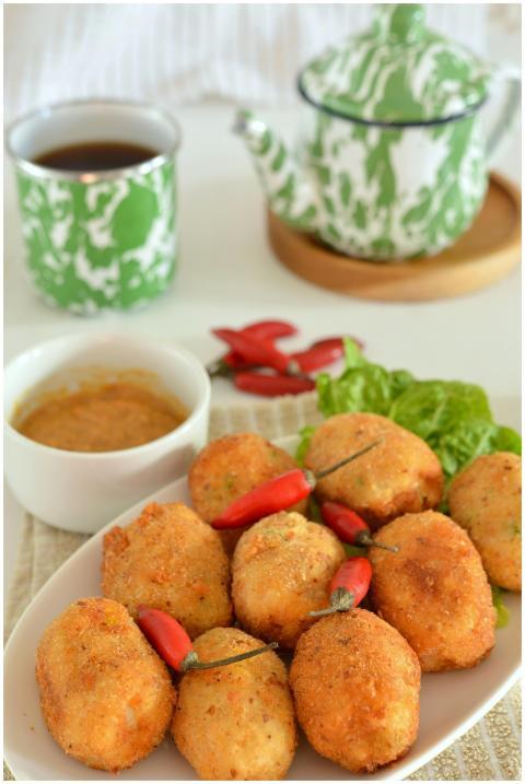 Close-up of fried croquettes with chili peppers, t