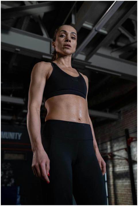 Strong woman in gym attire showcasing fitness and