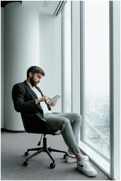 Professional man in contemporary office using tabl