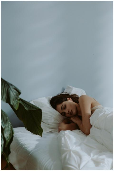 A serene scene of a woman sleeping in a cozy bedro