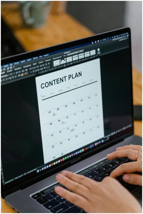 Close-up of hands typing on a laptop displaying a
