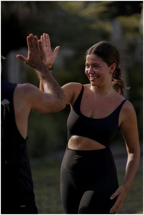 Two adults celebrating with a high-five during an