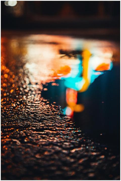 Vibrant neon lights reflect on a wet street creati