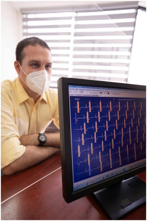 Doctor analyses heart monitor readings on a comput