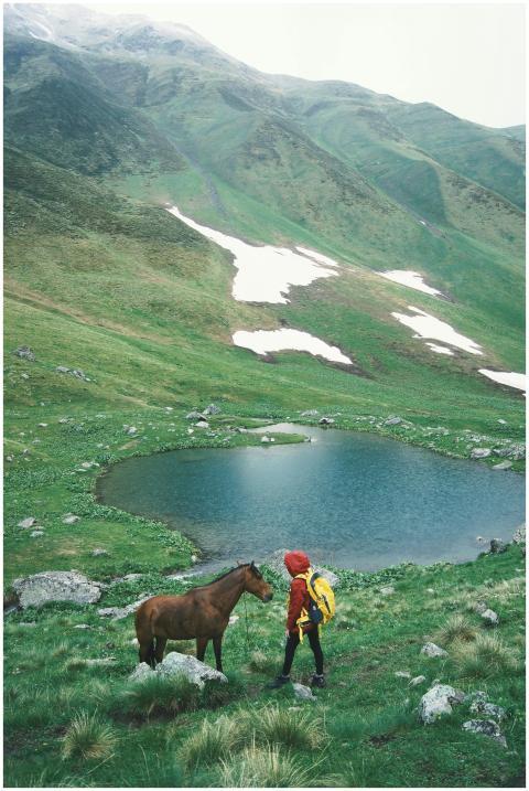 Serene mountain landscape featuring a lone hiker a