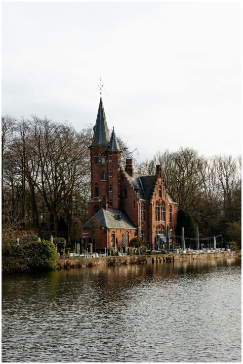 A picturesque Gothic building along a serene canal