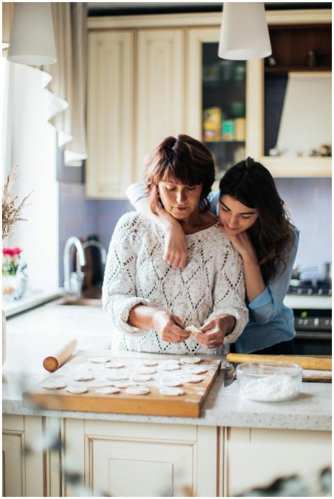 A mother and daughter bond while preparing traditi