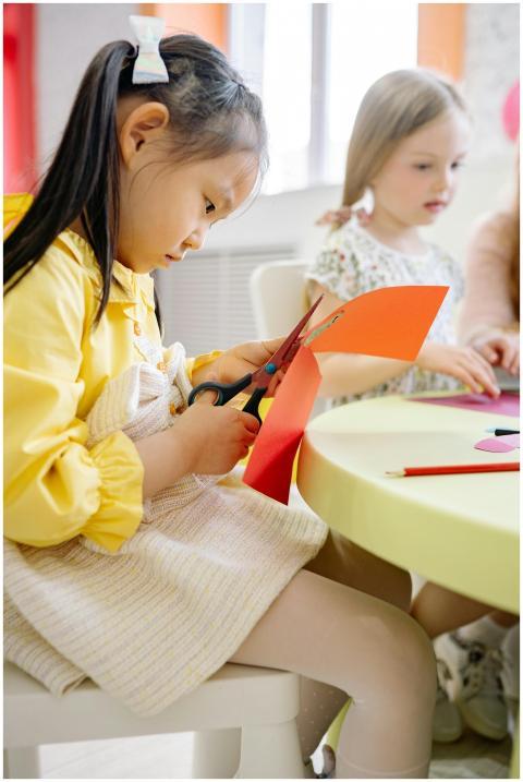 Young girls enjoying arts and crafts in a classroo