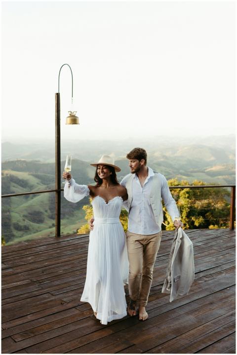 A smiling couple in wedding attire enjoying a roma