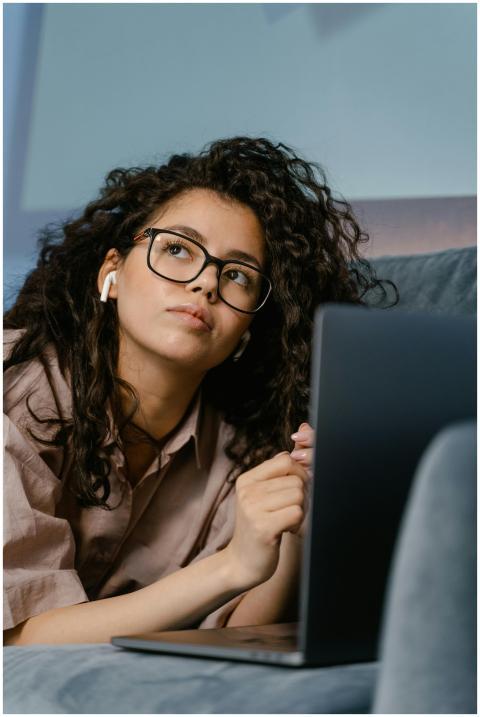 Portrait of a thoughtful young woman with curly ha