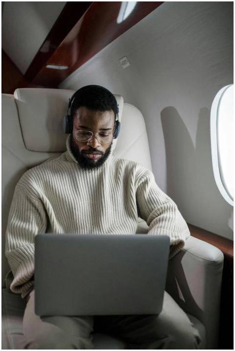 A focused businessman using a laptop and headphone