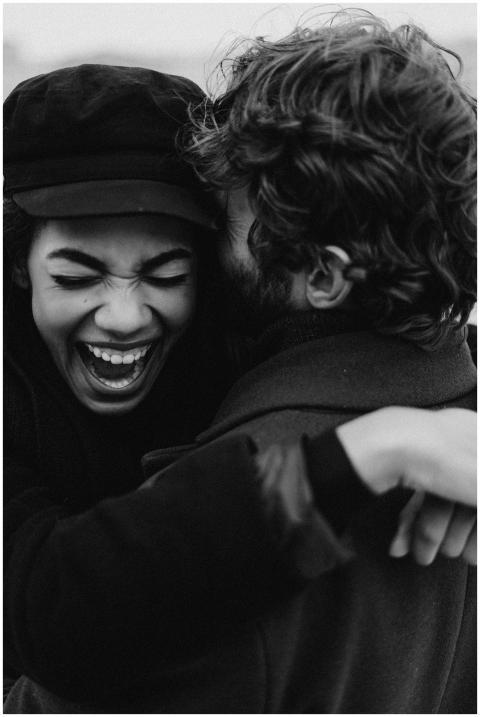 Monochrome image of a joyful couple embracing with