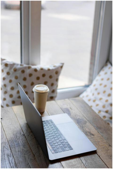 A serene workspace setup featuring a laptop and co