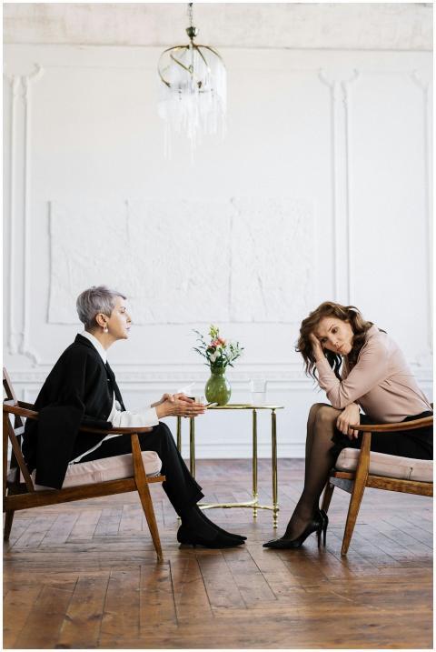Two women engaged in a counseling session, discuss