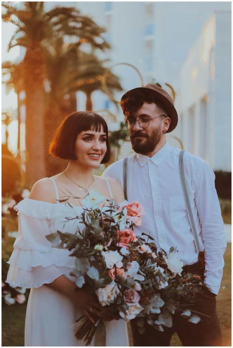 A joyful couple dressed in wedding attire enjoying