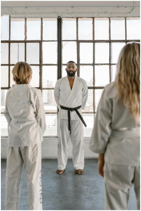 Martial arts instructor and students practicing in