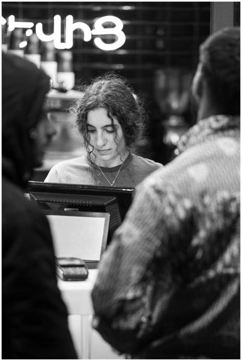 Customer interaction in a night cafe, captured in