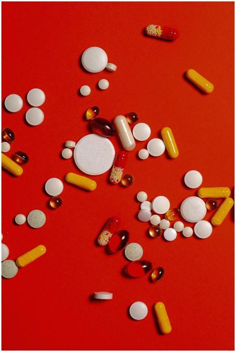 A diverse array of pills and capsules scattered on