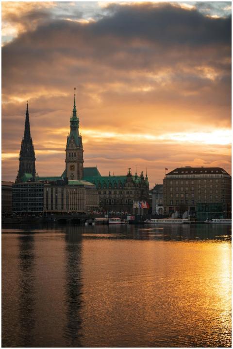 Dramatic view of Hamburg's skyline at sunset featu