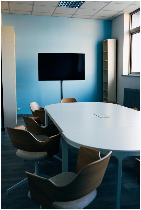 Comfortable chairs and oval table in modern confer