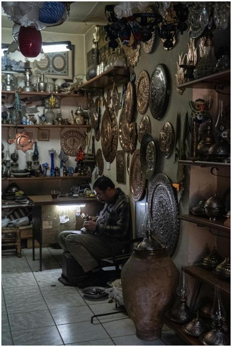A local artisan meticulously crafting metalwork in