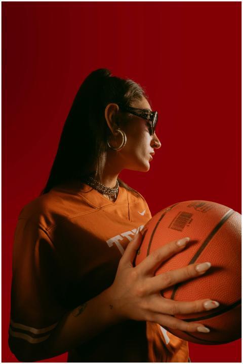 Profile of a fashionable woman with sunglasses hol