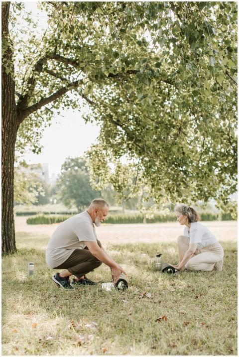An elderly couple engaging in outdoor exercise wit